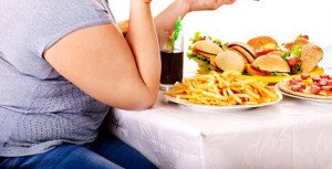 Big woman eating fast food and watching TV. Isolated.